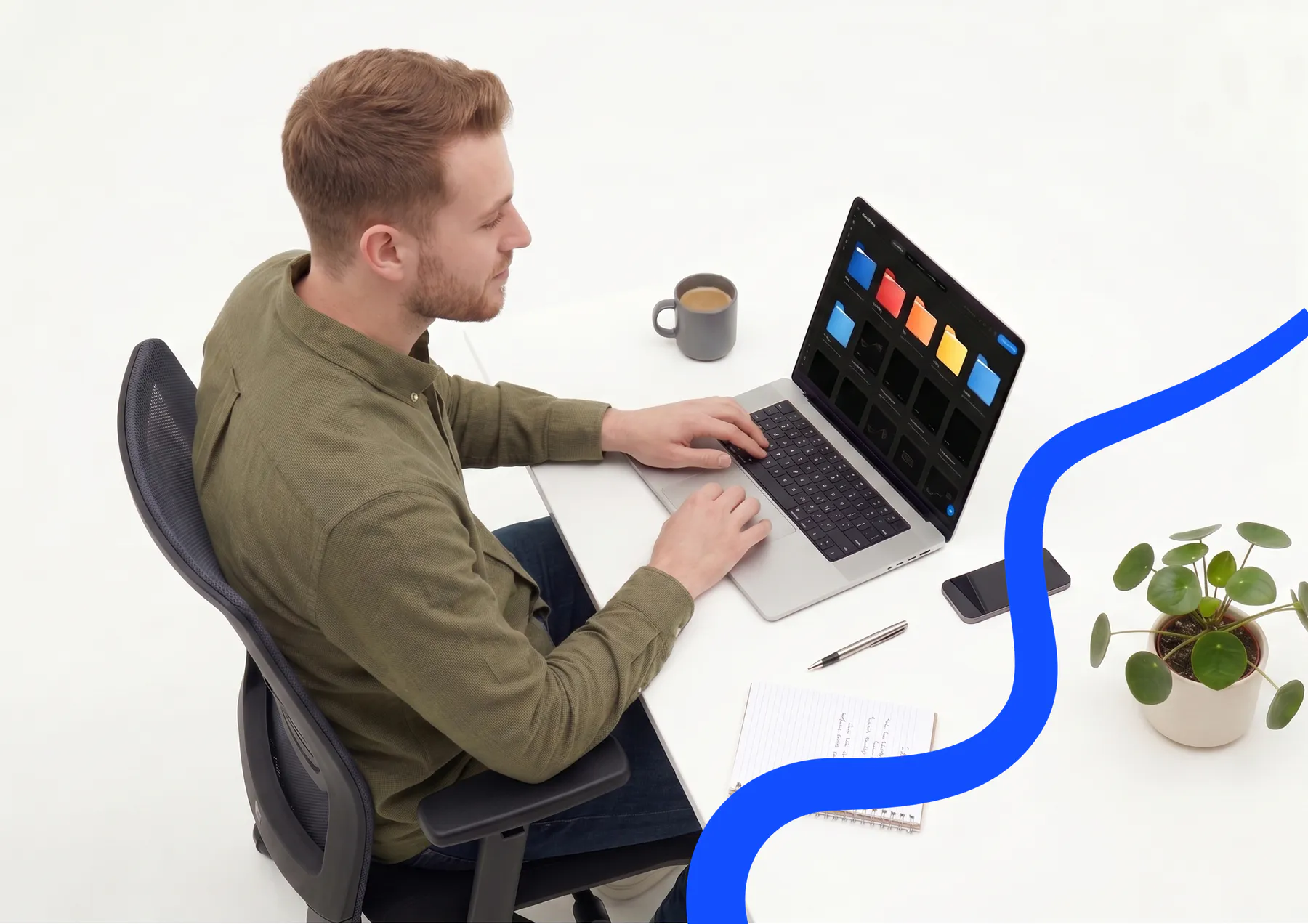 A person working at a laptop showing the Flero workspace of colour-coded folders, at a tidy white desk with a coffee, notebook and plant