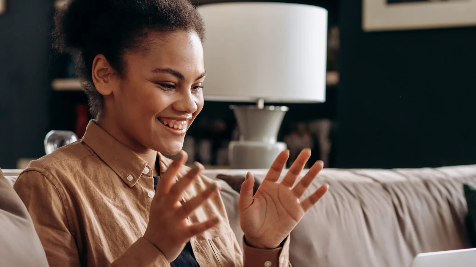 A person smiling on a video call at home