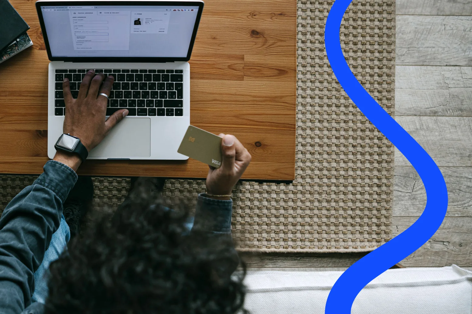 Someone completing an online store checkout on a laptop, holding a payment card
